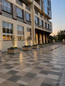 a building with a checkered floor in front of it at GLOW Suites in Naivasha
