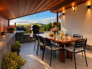a patio with a table and chairs and a grill at Tea Vendégházak in Ghiduţ +78 photos