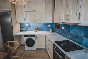 a kitchen with wooden cabinets and a dishwasher at Calliοpe's home in Skiathos