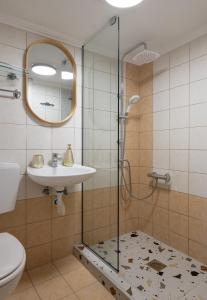 a bathroom with a shower and a sink at Tsamakdas House in Toroni +26 photos
