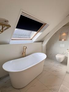 a bathroom with a bath tub and a sink at Frissestein in Deil +67 photos