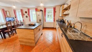 a kitchen with a sink and a counter top at Chalupa Šumburk in Svárov