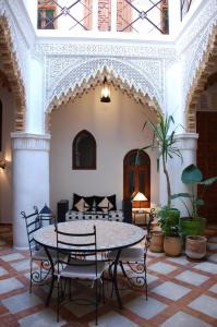 a dining room with a table and chairs at Riad Dar Soufa in Rabat