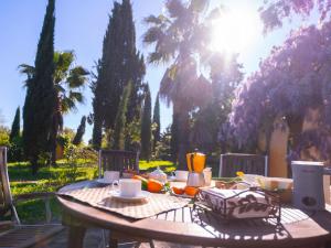 a wooden table with food on top of it at Cortijo Negretti in Herrera de Alcántara