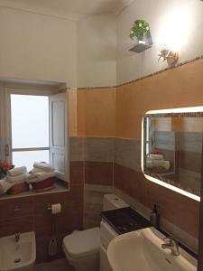 a bathroom with a sink and a toilet and a mirror at Collina Blu in Cuglieri +45 photos