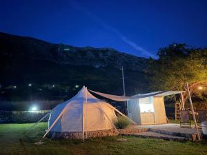 a tent in a field at night at Lisinj Sky Glamping in Bar +4 photos