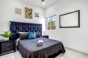 a bedroom with a large bed and a window at Dog-friendly home 3 rows to beach with rooftop deck, pool, hot tub, & kitchen in Rosarito +41 photos