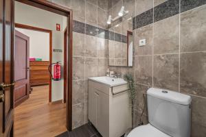 a bathroom with a toilet and a sink at Casa Sol in Praia do Carvoeiro +20 photos
