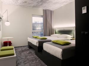 a hotel room with two beds and a window at ibis Tallinn Center in Tallinn +135 photos