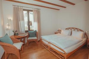 a bedroom with a bed and a table and chairs at Hotel Sass da Grüm in Vairano +7 photos