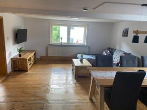 a living room with a couch and a table at NEU! Ferienwohnung Bruno in Gersfeld