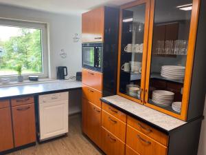 a kitchen with wooden cabinets and a counter top at NEU! Ferienwohnung Bruno in Gersfeld
