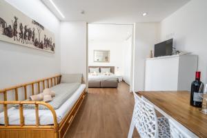 a living room with a couch and a refrigerator at Hotel Aurora & Appartamenti in Nago-Torbole