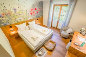 a small bedroom with a bed and a window at Waldhotel Hohe Sonne Eisenach in Eisenach