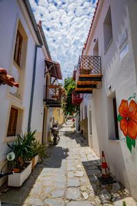 an alley with buildings and a motorcycle parked on a street at Calliοpe's home in Skiathos