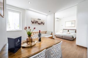 a living room with a table with a vase of flowers at Hotel Aurora & Appartamenti in Nago-Torbole +143 photos