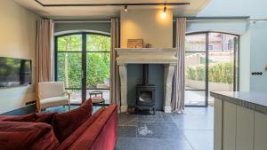 a living room with a fireplace and a couch at Bakkumer Strand in Castricum