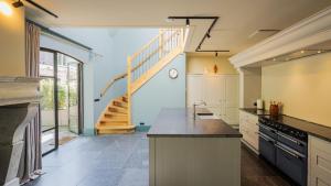 a large kitchen with a staircase in the background at Bakkumer Strand in Castricum