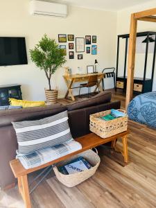 a living room with a couch and a table at Casa Swift in McLaren Flat