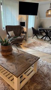 a living room with a couch and a coffee table at Ferienwohnung De ole School mit eigener Sauna! in Fehmarn