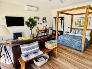 a living room with a bed and a couch at Casa Swift in McLaren Flat