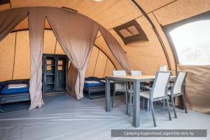 a tent with a table and chairs in it at Texelcampings - Kogerstrand in De Koog