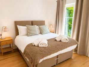 ein Schlafzimmer mit einem Bett, auf dem Handtücher liegen in der Unterkunft Watersmeet View in Lynmouth