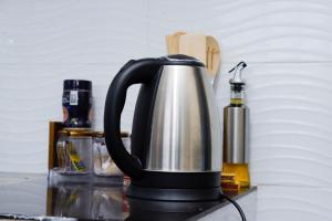 a black and silver coffee pot sitting on a counter at JS Urban Stays in Gatunga