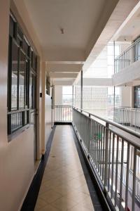 an empty hallway in a building with windows at JS Urban Stays in Gatunga