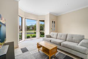 a living room with a couch and a table at Leopold holiday home in Leopold