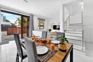 a dining room with a table with food on it at The Jacuzzi Escape in Flic-en-Flac