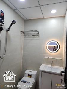 a bathroom with a sink and a toilet and a mirror at Minihouse Út Thiểu in Rạch Giá +7 photos