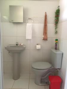 a small bathroom with a toilet and a sink at Suítes Dona Ilda in Pirenópolis +24 photos