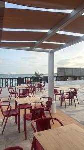 a group of tables and chairs on a patio at Hotel Dunas Boavista in Sal Rei