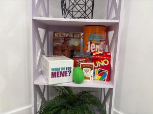 a book shelf with food and other items on it at Silverado Suite Modern Quiet 2BR Queen's Downtown in Kingston +40 photos