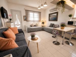 a living room with a couch and a table at Elia Apartment Garden Oasis With Pool Astros in Paralio Astros