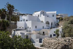 a cluster of white houses on a hill at Elios Cave Suites in Oia