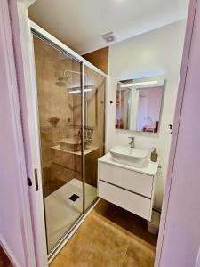 a bathroom with a white sink and a shower at Casa Laura João in Monsanto