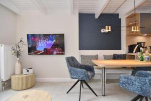 a dining room with a table and two chairs at Alma & Eva, Whg 5 in Westerland +16 photos
