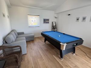 a living room with a pool table and a couch at Holiday Home Valica in Malinska