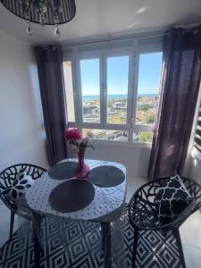 a table and chairs with a vase with flowers on it at Studio La Calita in Mijas Costa +35 photos