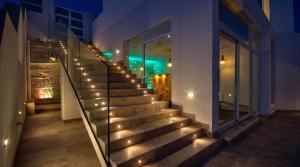 a staircase with lights on the side of a building at Villa Ghea - Indoor Jacuzzi Pool, Sauna and Games Room in Mellieħa