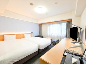a hotel room with a bed and a desk at Richmond Hotel Hakata Ekimae in Fukuoka