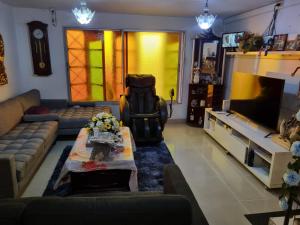 a living room with a couch and a flat screen tv at Hotel Simon in Antofagasta