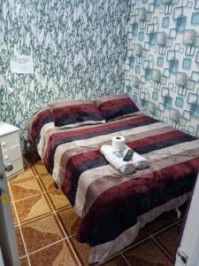 a bedroom with two beds with towels on it at Hotel Simon in Antofagasta