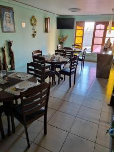a dining room with wooden tables and chairs at Hotel Simon in Antofagasta