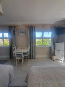 a bedroom with a bed and a table and chairs at Spring Grove Guesthouse in Donegal +16 photos