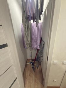 a hallway with purple umbrellas and a walker in a room at Urban Place by Kelvin in Narva