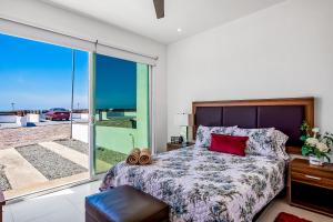 a bedroom with a bed and a sliding glass door at Dog-friendly Villa with Heated Pool, Hot Tub, Streaming, Partial Ocean Views in Rosarito +42 photos