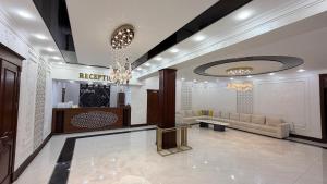 a lobby with a couch and a table in a building at Turon plaza hotel in Bukhara